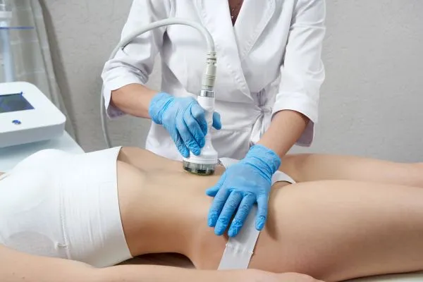 Lost the Weight but Not the Loose Skin? 2 woman having HIFU treatment on her stomach to combat loose skin Chesham following weight loss